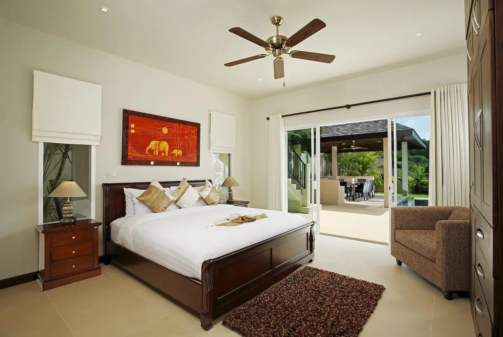 Bedroom 3, with king size bed, en-suite bathroom and sliding doors to the outside sun deck and swimming pool