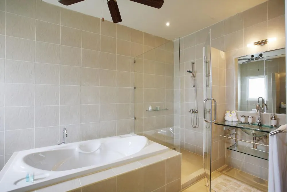 Large master en-suite bathroom with bath, walk-in shower and two wash hand basins