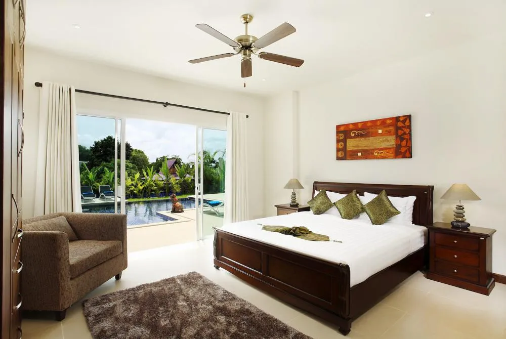 Bedroom 4 with king size bed, en-suite bathroom and direct access to swimming pool and sundeck